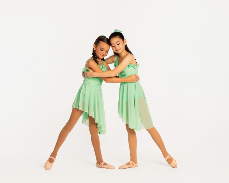 Two dancers posing together at their dance studio photo day.