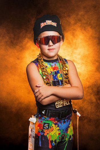 young central florida flag football player photographed with orange lighting and smoke in the bartow, florida studio