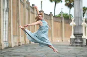 high school senior dancer leaping at her senior photo session in downtown lakeland, florida