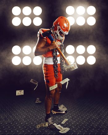 high school football media day portrait of player holding sledge hammer with cash falling around him