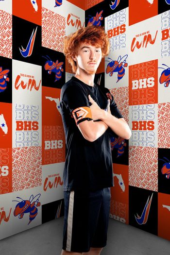 bartow, florida soccer player in front of school media panels on media day