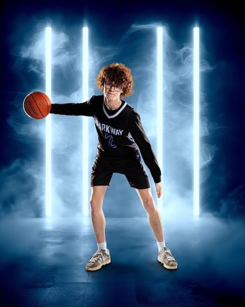 school sports photo of male basketball player in front of led tube light and smoke digital backdrop