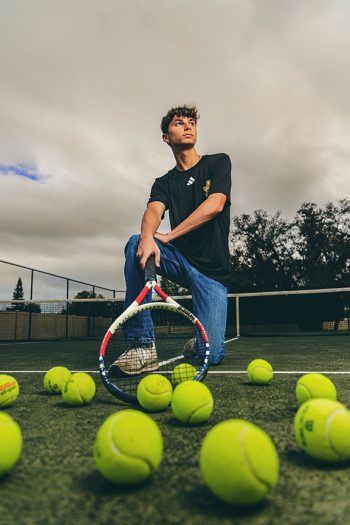 tennis player with racket and tennis balls at auburndale tennis court