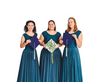 High school seniors posing with their graduation caps on central florida dance studio.