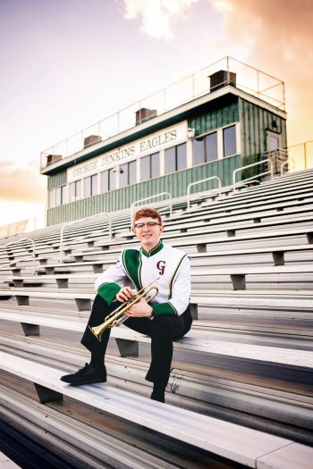 High school senior photoshoot for george jenkins high school drum major at football stadium.