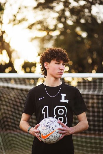 soccer player portrait in front of soccer goal holding soccer ball in lakeland, florida