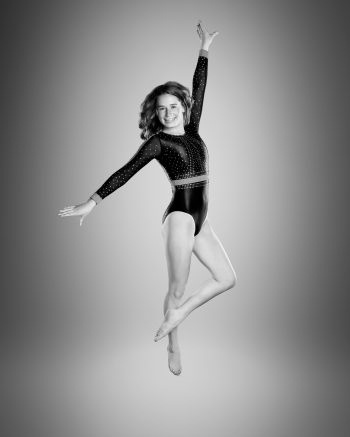 Photo of gymnast leap taken by gymnastics photographer bc visuals