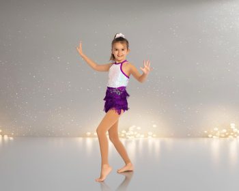 dancer with fringe skirt posing on a digital background.