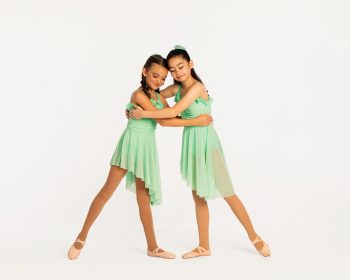 Two dancers posing together at their dance studio photo day.