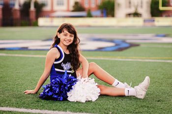 cheer media day pose on football field using natural light