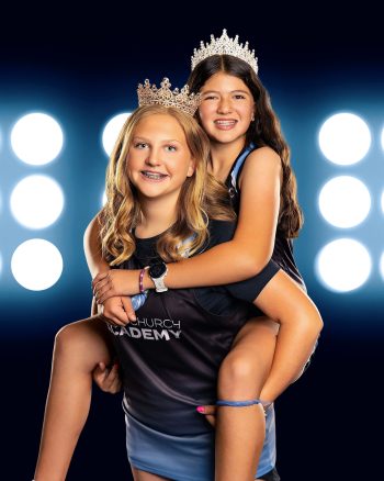 sports buddy photo with girls wearing tiaras on a digital background.