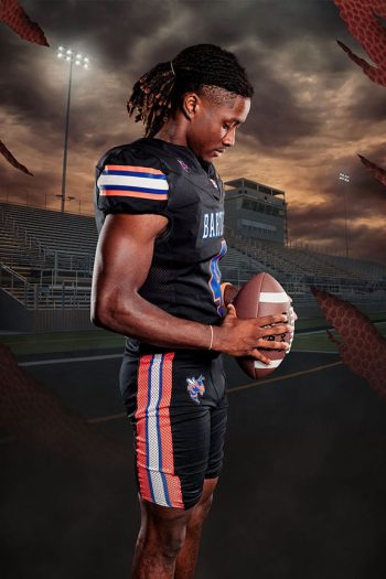 High school football player taken at a team media day with a football stadium digital background in Bartow, Florida.