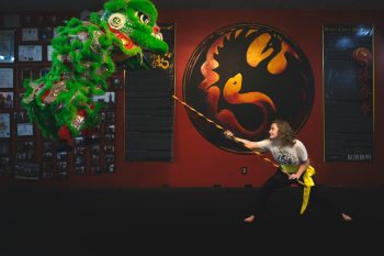 High School Senior martial arts student posing in her lakeland, Florida gym for senior photos.