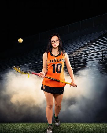 lakeland, fl lacrosse player on a digital background showing lacrosse field and smoke
