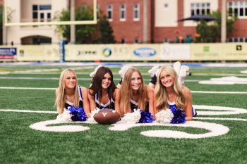 cheerleading buddy pose on football field in lakeland, florida