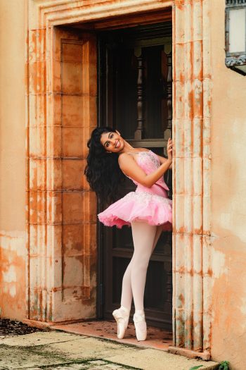 High school senior ballerina wearing point shoes and a tutu posing at Bok Tower, Florida
