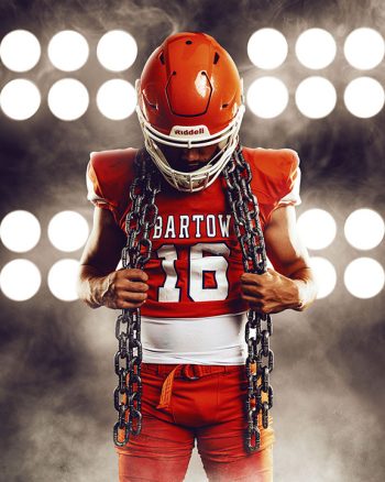high school senior football player portrait with chains on a digital background with dramatic smoke
