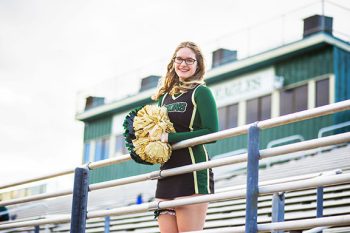 high school senior cheerleader portrait at the school football stadium