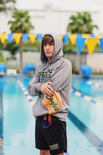 swim team media day at school pool using natural light